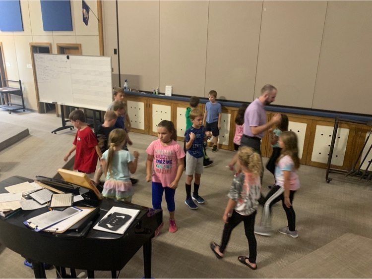2nd grade demonstrate the Do-Si-Do while square dancing with the new music teacher, Mr. Dodson.